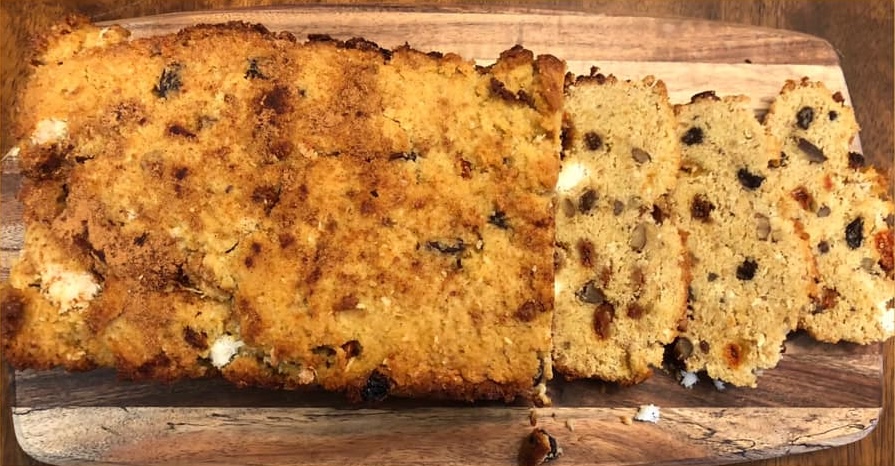 Loaf of Bread with Slices. On the inside you can see almonds and dried fruit.